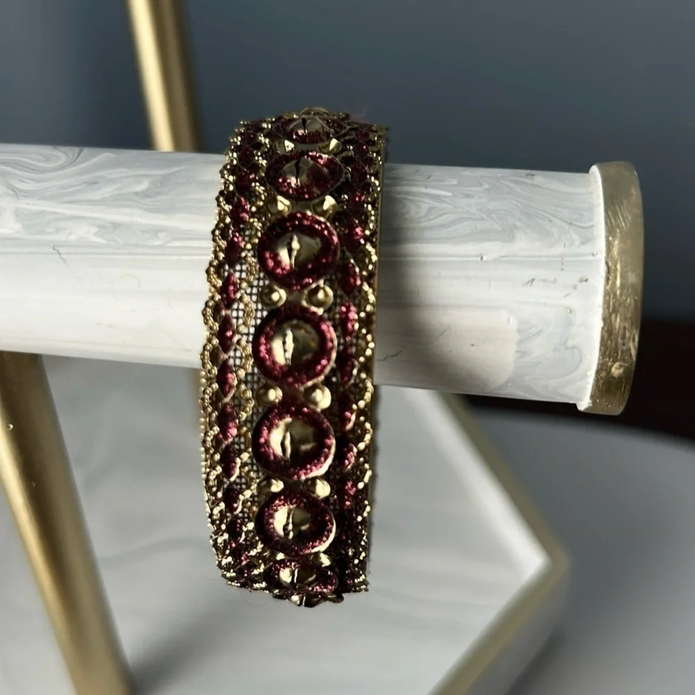 Gold filigree bangle with red accents